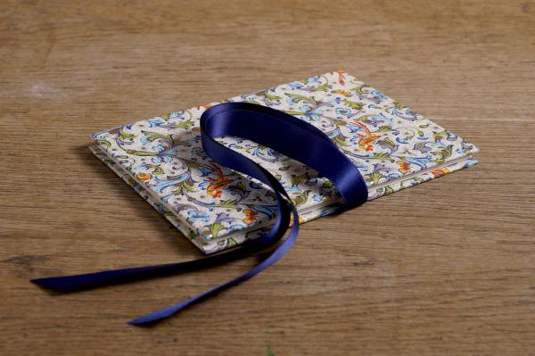 Foldable photo album with colorful birds and ribbon